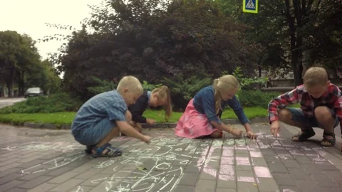 Children draw with chalk on the pavement. Video stock 79584823