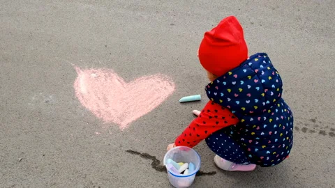 Children draw with chalk on the pavement. Selective focus. Stock Footage 237444033