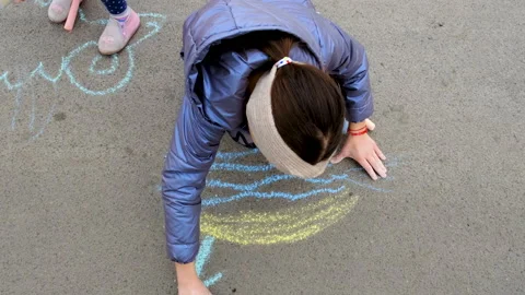 Children draw with chalk on the pavement. Selective focus. Stock Footage 237445149