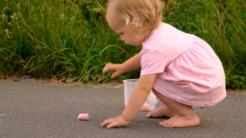 Children draw with chalk on the pavement. Selective focus. Stock Footage 294186967