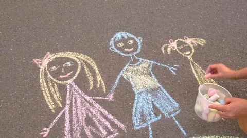 Children draw with chalk on the pavement. Selective focus. Stock Footage 294316715