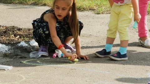 Children draw with chalk on the road. Stock Footage 98596177