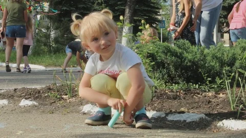 Children draw with chalk on the road Stock Footage 98596187