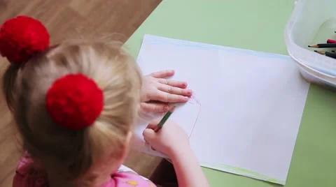 Children draw with crayons on a sheet of paper horrible drawings Stock Footage 53753412