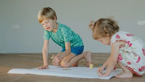 Children Draw On A Large Sheet Of Paper. Stock Footage 101184238