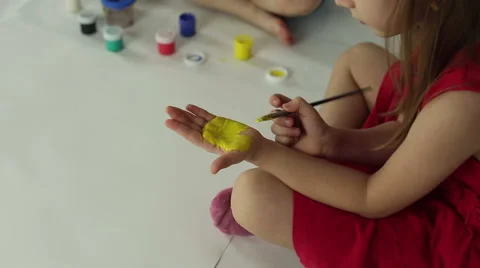 Children draw on paper with brushes, palms and gouache Stock Footage 60643725