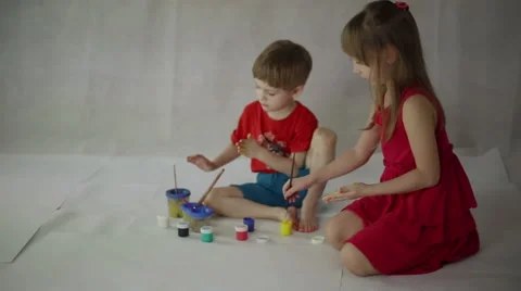 Children draw on paper with brushes, palms and gouache Stock Footage 60643930
