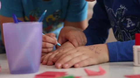 Children draw with a pen on hand Stock Footage 63220740