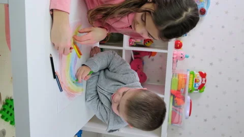 The children draw a rainbow together. Selective focus. Stock Footage 194770216