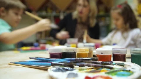 Children draw with the teacher bokeh Stock Footage 59595895