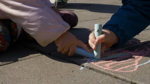 Children drawing on asphalt with chalks/crayons Stock Footage 91107421