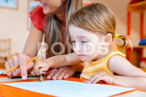 Children drawing with pencils in play school Stock Photos