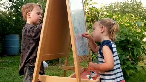 Children drawing on whiteboard in yard Stock Footage 135796014