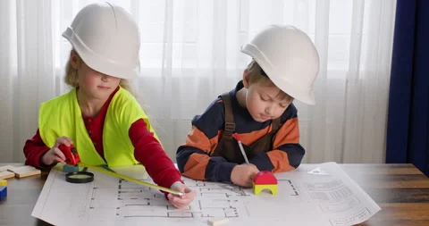 Children dressed as builders play Stock Footage 240571337