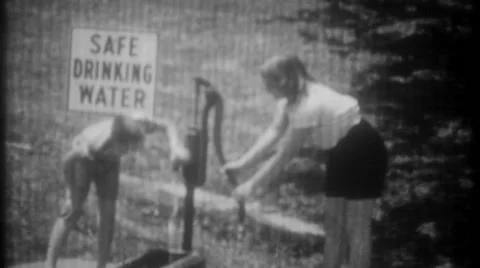 Children drink from well marked Safe Drinking Water 1950 vintage home movie 3329 Stock Footage