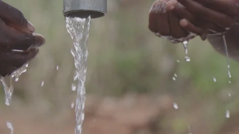 Children drinking water at the pump Stock Footage 74390741
