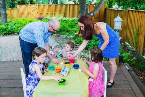 Children Dyeing Easter Eggs with Mother and Father Stock Photos