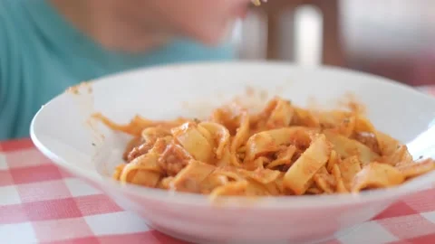 Children eating italian pasta dish healthy food summer healthy lifestyle fun Stock Footage 195970853