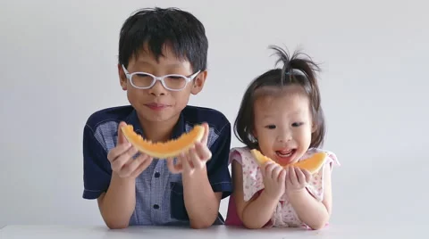 Children eating melon Stock Footage 56624685