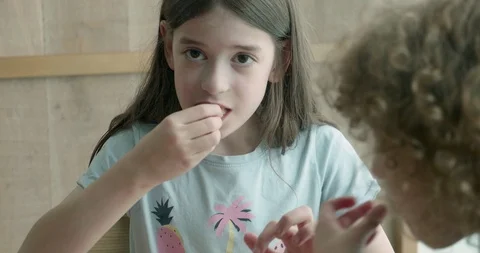 Children eating quickly as the camera pans around them Stock-Footage 107456088