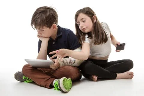 Children engrossed in technology Stock Photos