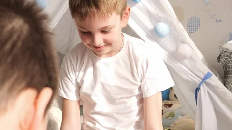Children enjoy playing on the floor, which promotes creativity, laughter and Stock Footage 275889063