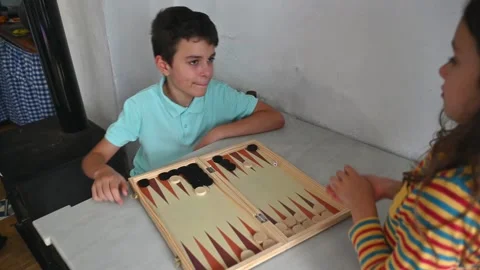 Children enjoying a backgammon game at a cozy home setting Stock Footage 290051285
