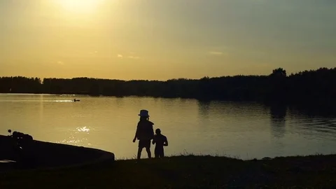 Children at the evening lake Stock Footage 79664763