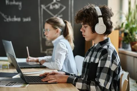 Children examining new computer software at lesson Stock Photos