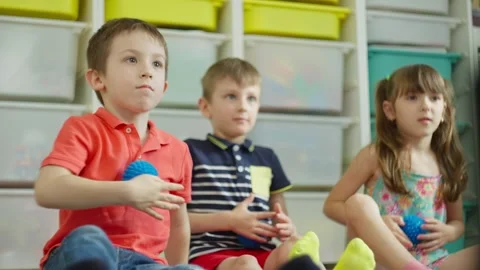 Children exercise between lessons using a massage ball. Stock Footage 276922495