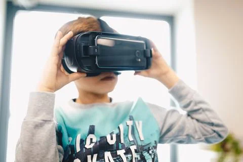 Children experiencing virtual reality at school. Amazed child with VR Stock Photos