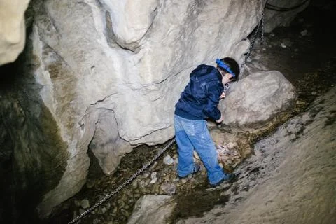 Children explore underground caves, an underground karst complex of Cunardo,  Stock Photos