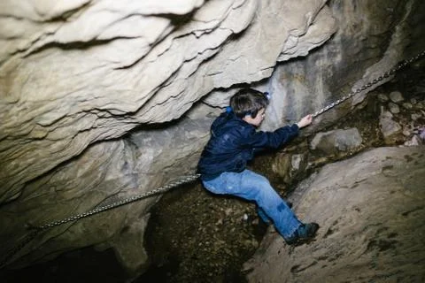 Children explore underground caves, an underground karst complex of Cunardo,  Foto stock
