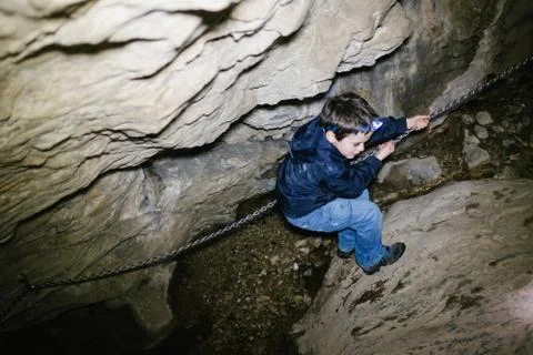 Children explore underground caves, an underground karst complex of Cunardo,  Stock Photos