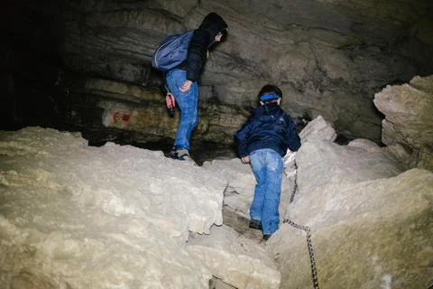 Children explore underground caves, an underground karst complex of Cunardo,  Stock Photos