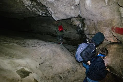 Children explore underground caves, an underground karst complex of Cunardo,  Stock Photos