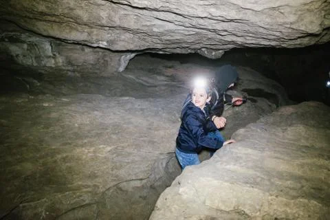 Children explore underground caves, an underground karst complex of Cunardo,  Stock Photos