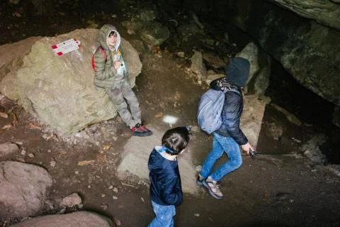 Children explore underground caves, an underground karst complex of Cunardo,  Foto stock