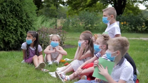 Children with face mask going back to school after pandemic lockdown, learning Stock Footage 136671880