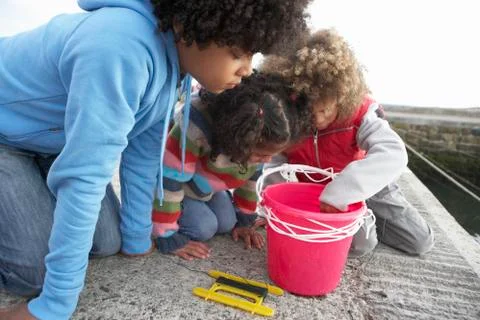 Children fishing for crabs Stock Photos