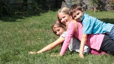 Children fool around on the grass Stock-Footage 83262785