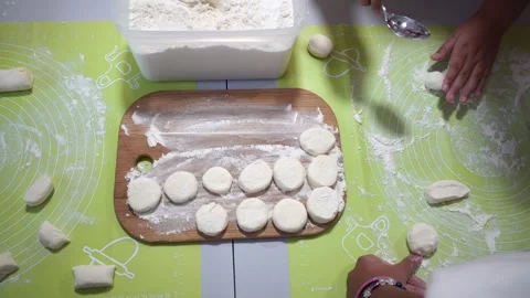 Children form circles of dough. Making sweet syrniki. Stock Footage 318168152