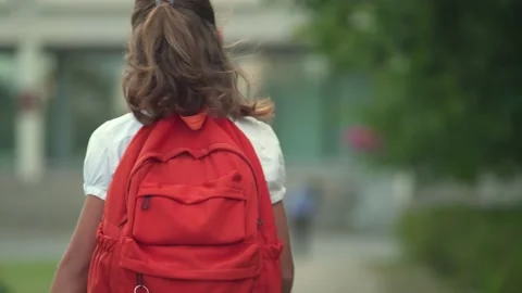 Children go back to school. Cute pupils with backpacks. Boy and girl in safety Stock Footage 136101473