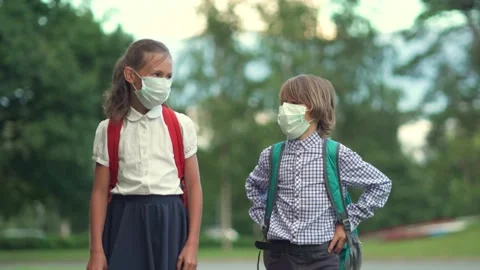 Children go back to school. Cute pupils with backpacks. Boy and girl in safety Stock Footage 136102198