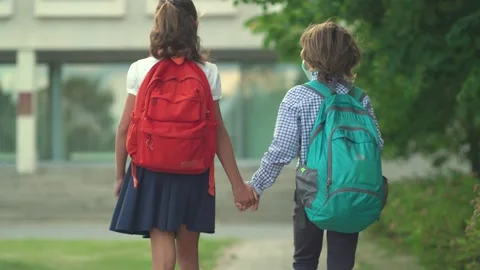 Children go back to school. Cute pupils with backpacks. Boy and girl in safety Stock Footage 136511685
