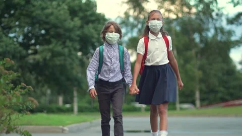 Children go back to school. Cute pupils with backpacks. Boy and girl in safety Stock Footage 137085830