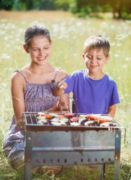 Children grilling vegetable 写真素材