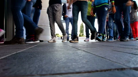 Children in groups passing through the entrance of the school Stock Footage