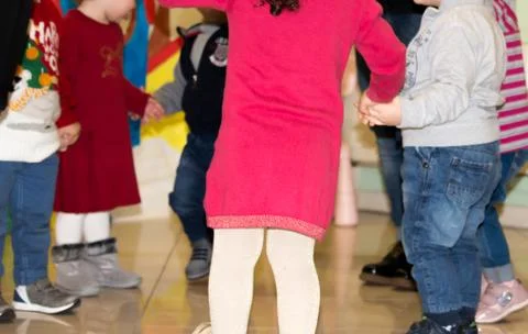 Children hand in hand while doing the round dance Stock Photos