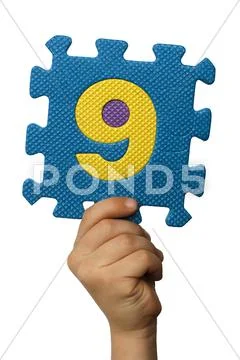 Children hand holding the number nine. white isolated number Stock Photos